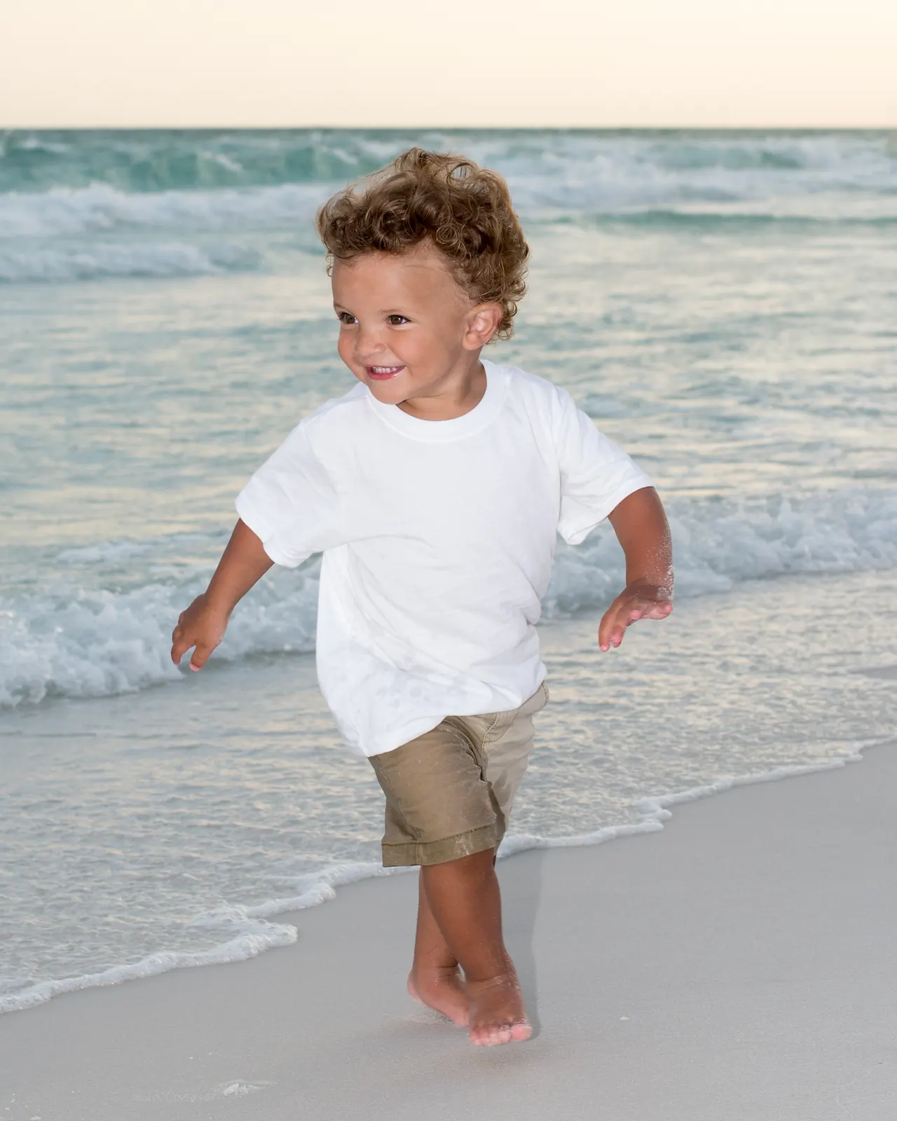 Toddler running in the surf