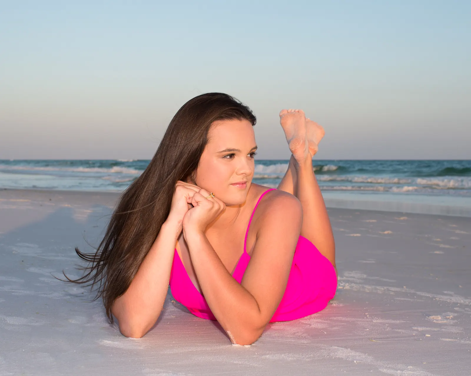 Senior portrait lying in the sand