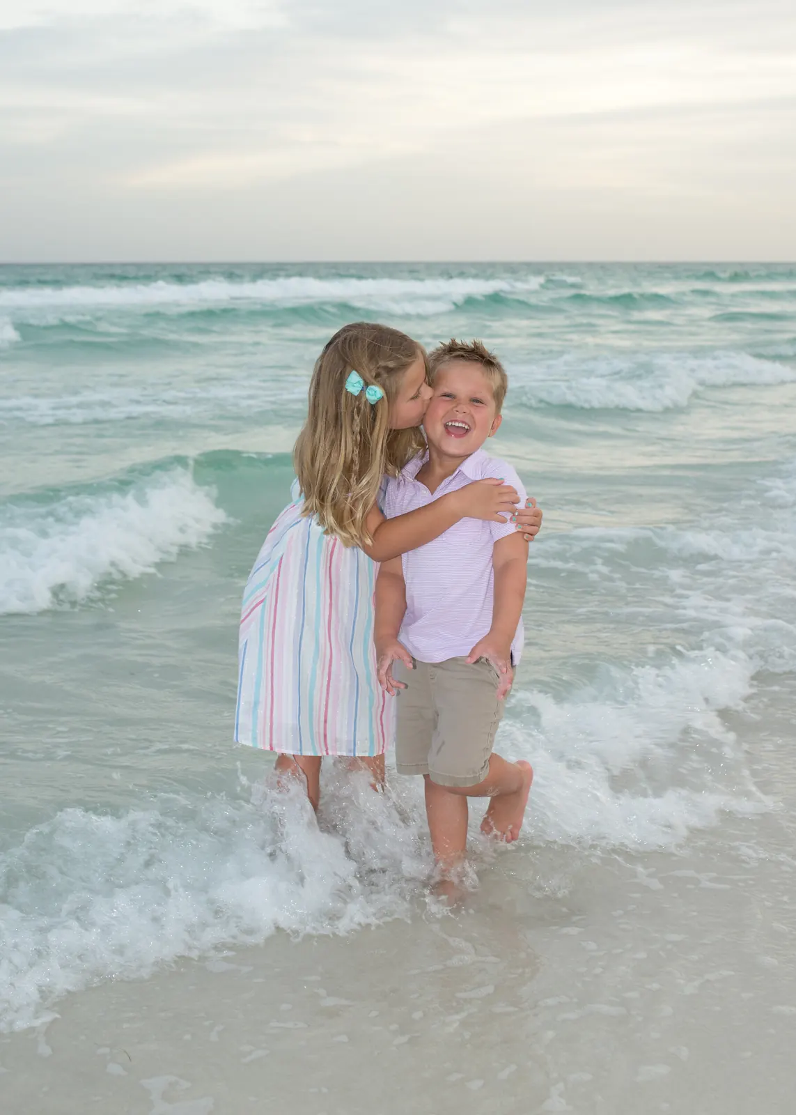 Brother and sister playing in the waves